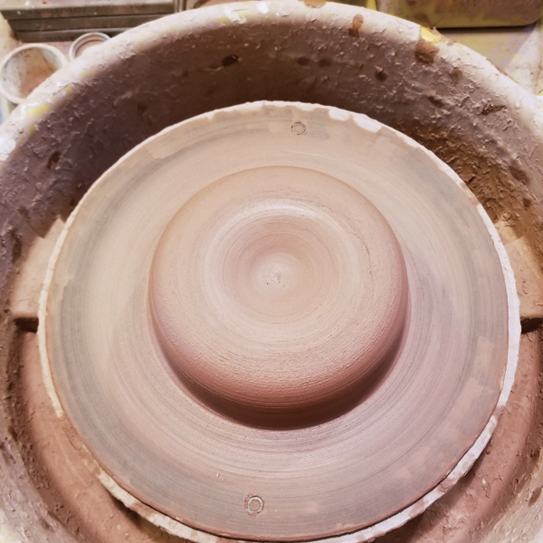 1 Center 3½ pounds of clay (or a little more if you want a wide rim) into a low puck.