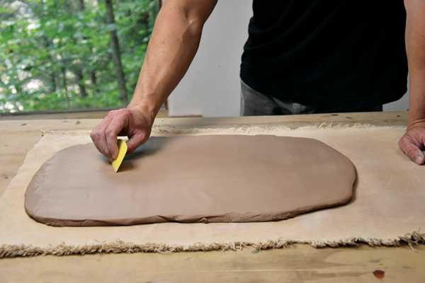 1 Roll a slab to approximately ½-inch thick. Compress both sides of the slab using a soft rubber rib.