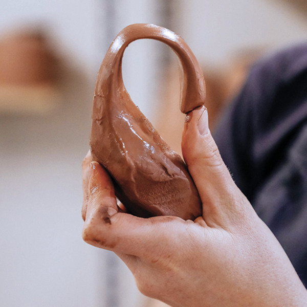 C Pull a handle from a lug of clay, then curve it into the desired shape and set aside to reach soft leather hard. 