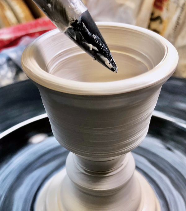 4 Use a rubber-tipped tool to add detail to the cup and create a glaze break.