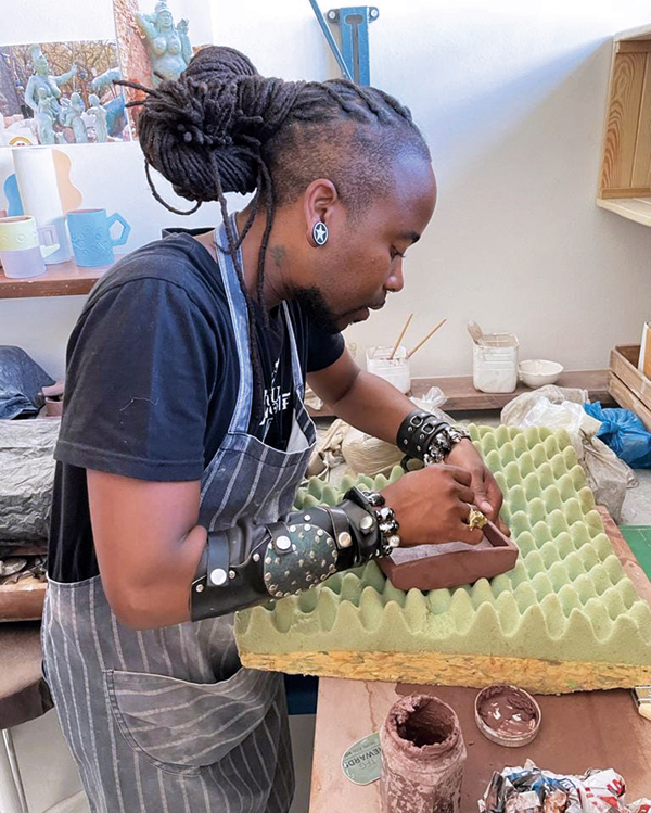 1 Sandile Brian Cele handbuilding a container in his studio. 