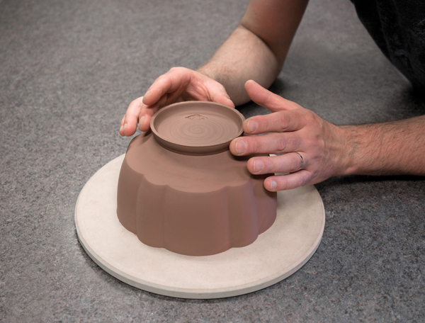 Attaching the foot onto the bowl using casting slip as a joining slip.