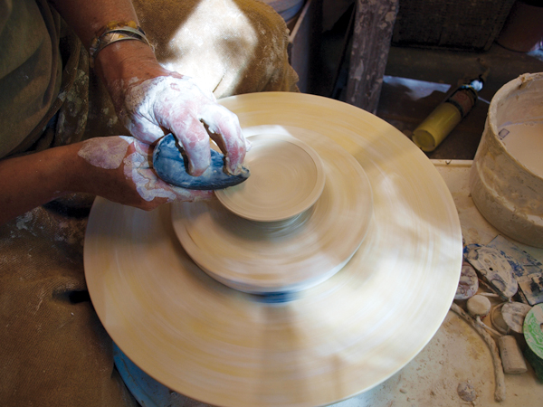 5 To make the lid, throw a V-shaped bowl, then shape to a plate-like domed curve with a flattened outside edge.