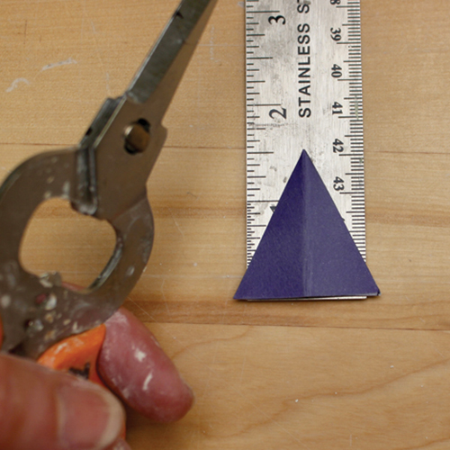 6 Cut out a triangle small enough to fit over the top of each clay applique.