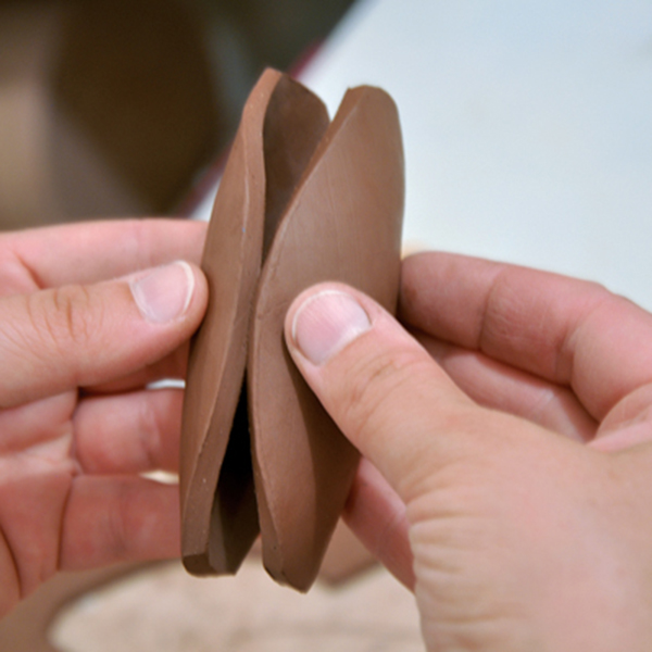 3 Form a pod shape and create volume by pressing the two halves together. Pinch the edges together, trapping air within.