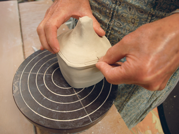 6 Place the roughly cut lid on the top jar and run a fingernail around the rim to mark the clay to cut off.