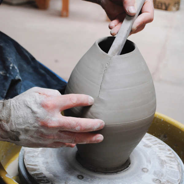 6 Compress and blend the seam using fingers on the outside and a wooden tool as a support on the inside of the pitcher.