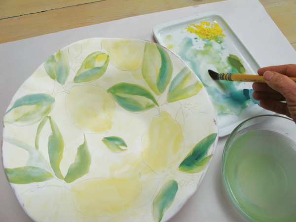 5 Finish painting the leaves, adding darker shading to the outside edges by double loading darker greens and blues.