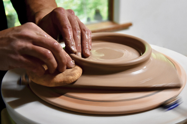 7 Using a light amount of water, blend the clay of the foot ring into the slab.