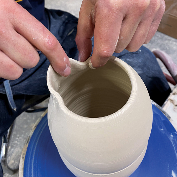 7 Gently push each side of the spout back toward the inside of the pot; this creates a pathway for the liquid to pour.