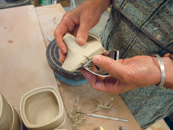 7 Use a Surform to cut away the excess clay from the lid up to the guideline made with your fingernail.