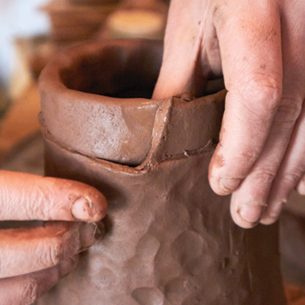 8 Attach a flattened coil to the top of the jug to add height and form the rim.