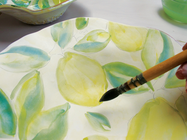 7 Shade the opposite side of each lemon to create depth, then add a little blue wash to the bottoms for a darker shadow.