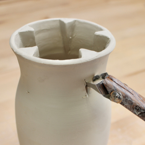 10 Push the extruder tool half way up the neck of the vase then stop.