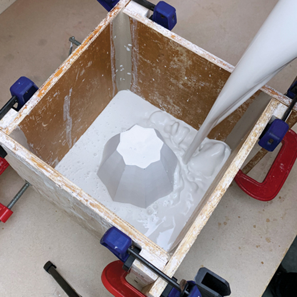 10 Slowly pour the plaster into the mold and cover the prototype.