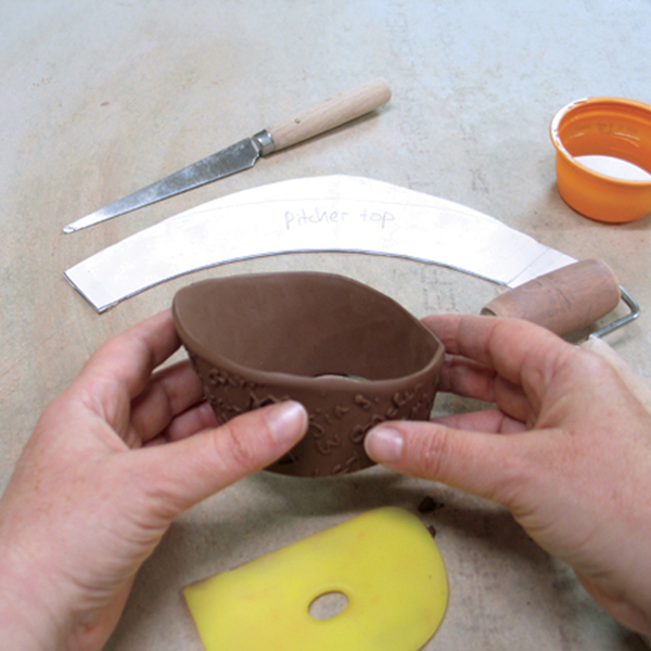 11 Bevel the edges, score and apply slip, and form the slab into the pitcher’s top.