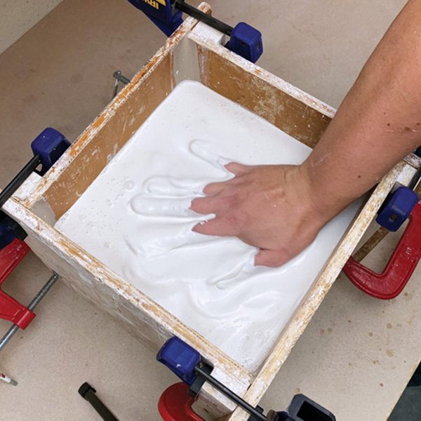 11 Use your hand to agitate the plaster to remove air bubbles.