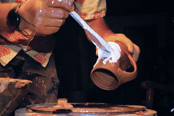 12 Use a hake brush to apply porcelain slip to the exterior of the mug. 