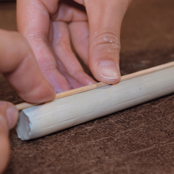 12 Use a wooden skewer to make light indents around the stem before carving it.