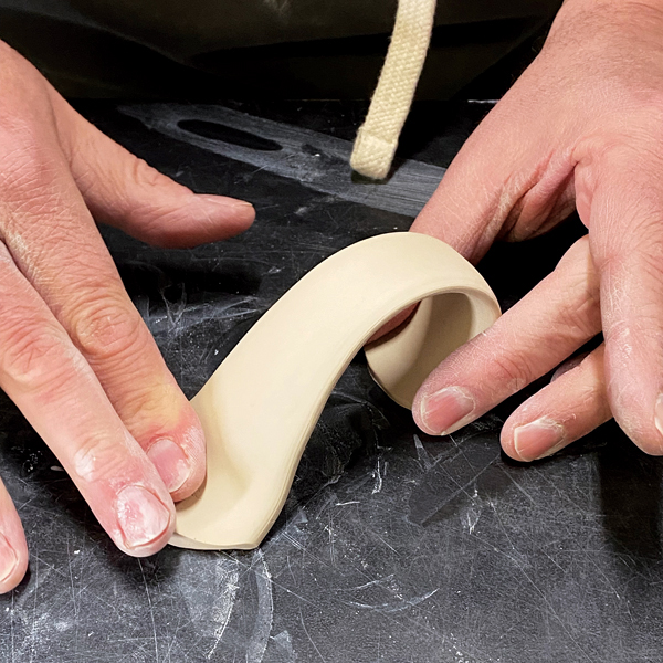 12 Curve and shape the handle as you will want it on the pot, then let it firm up to an early leather-hard stage.