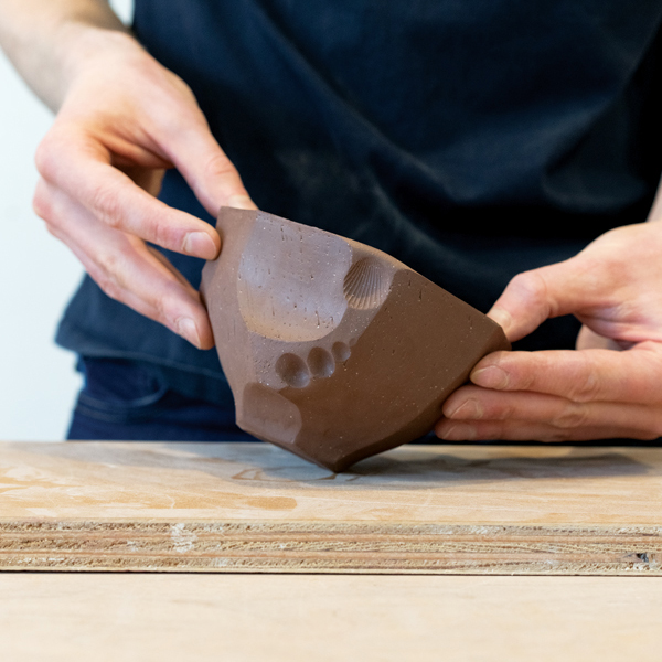 13 Roll the bowl at an angle to add a slight bevel to the foot to give it lift.