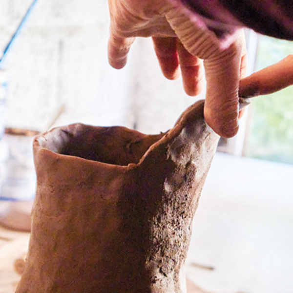 13 Refine the lip of the spout using both hands to pinch and form the final shape.