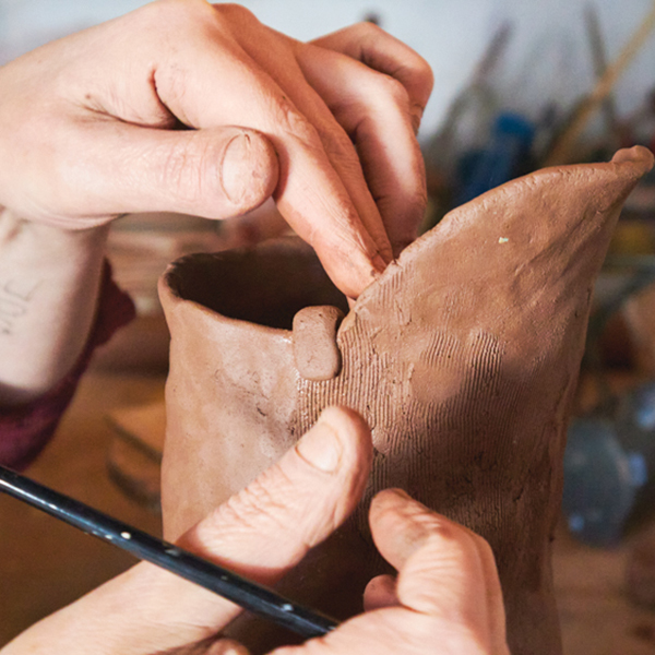 14 Add nubs of clay to the rim where the spout attaches as a decorative flourish. 