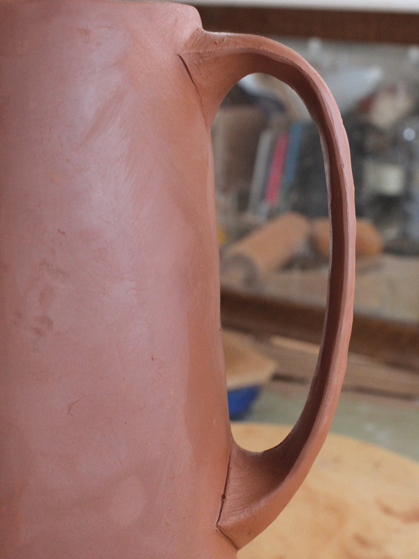 14 Score and apply slip to the handle and the pitcher, then attach them together. Compress, smooth, and refine the attachment with a rubber rib (alternate view).