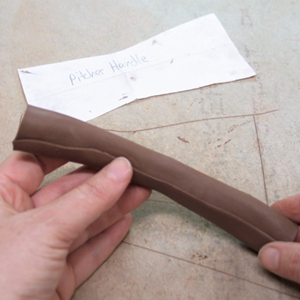 15 Thin the edges of the handle, then form a hollow tube shape.