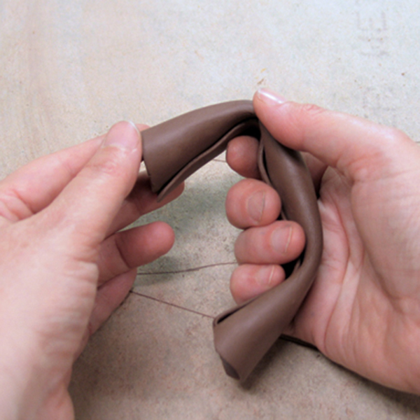 16 Form the handle by bending it around your fingers.