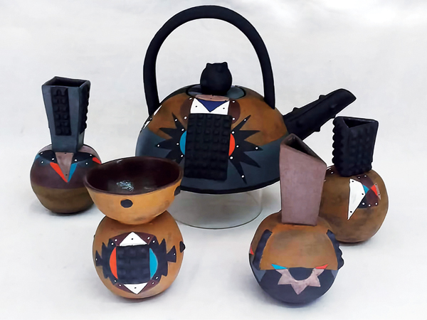 7 A collection of small Zulu Goth vases, with rounded calabash bases topped with a variety of collars, and matching teapot. Their colors and patterns draw directly from iziqhaza designs.