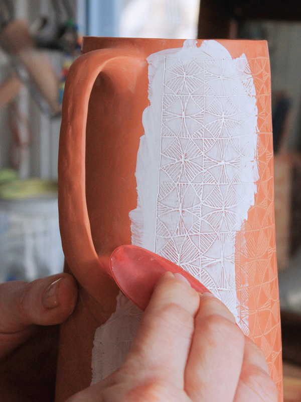 19 Remove the excess underglaze with a rubber rib to reduce waste and save underglaze.