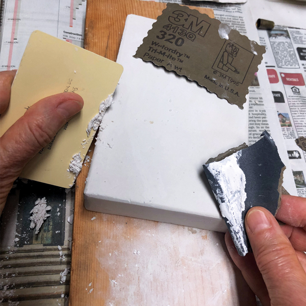 B Smooth the surface as needed with fine sandpaper and a plastic card while the plaster is still wet but solid. 