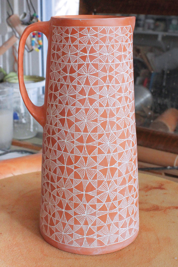 21 Continued: Use a damp sponge to remove additional underglaze from the clay surface. Continue this until you expose the entire carved pattern underneath. 