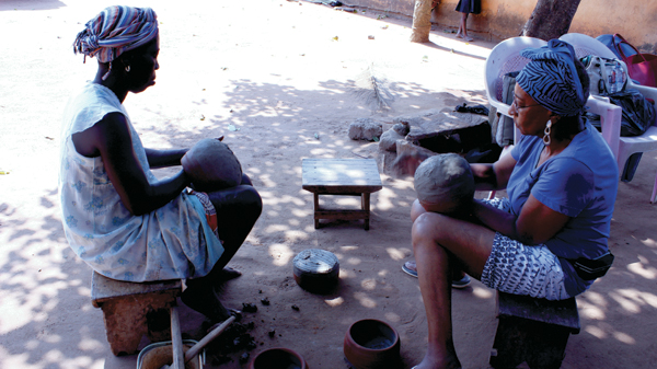 10 Peace (left) and Owens-Hart (right) working on finishing pots in Kuli Pottery Village.