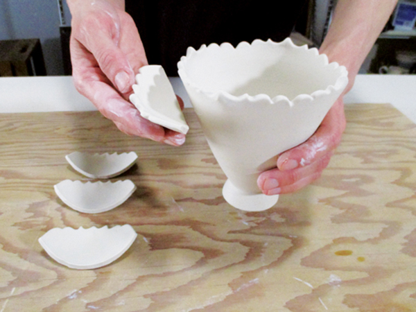 9 Cut large sections from the extra bowls and form into shapes that will compliment the base form.