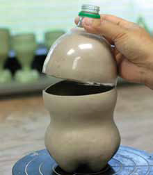 4 Use the top portion of the plastic bottle as a mold for the top of the vessel. Connect the two halves together.