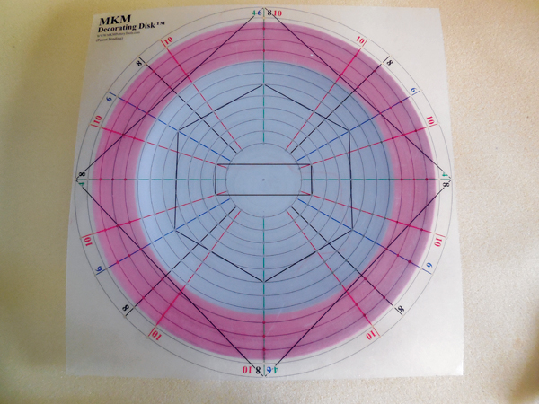 3 To begin adding your pattern, use a large MKM Decorating Disk to mark the outer edge of the platter.