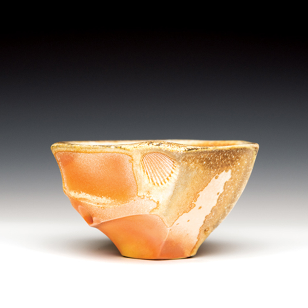 Wood-fired bowl, 3¾ in. (9.5 cm) in diameter, porcelain, shino liner glaze, wood fired to cone 10 in reduction, 2021. 