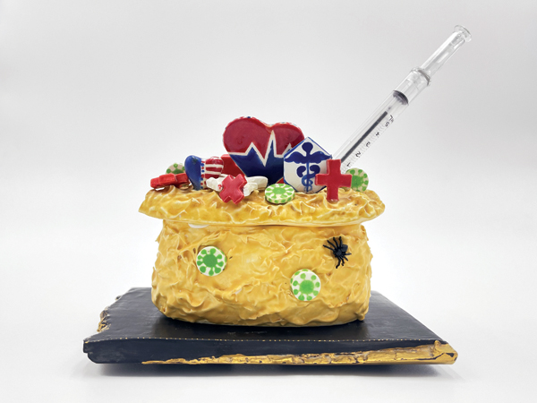 3 Joan Takayama-Ogawa’s America’s Healthcare Professionals’ Cake, 9 in. (23 cm) in height, earthenware, glaze, gold leaf, plastic syringe pen, 2021. Photo: Madison Metro, Craft in America.