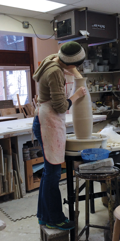 6 Guild member Autumn Aslakson throwing a tall pot. 