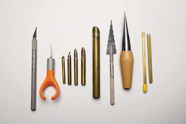 B A sampling of hole-cutting tools (left to right): X-Acto knife, Fiskars fingertip detail knife, an assortment of Kemper round hole cutters (minus handles), Kemper multi drill tool, van Gilder hole cutter, Kemper square hole cutter.