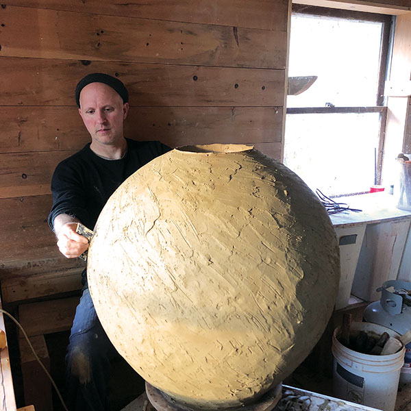 10 Michael Hunt making a large spherical vase using Onggi techniques at his Bandana Pottery studio in Bakersville, North Carolina, 2020. 