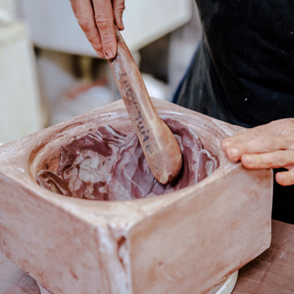 7 Use a rounded paddle to press the slices of marbled clay into even walls and to join the individual pieces together.
