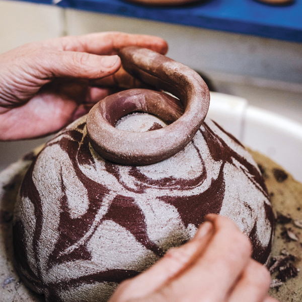 12 Roll a coil from the marbled clay and score and slip to attach it to the base of the leather-hard piece to create a foot ring.