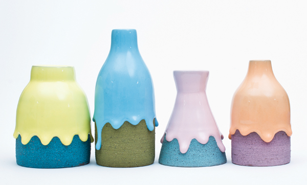 Brian Giniewski’s bud vases, varying sizes, earthenware, engobe, glaze, 2014. Giniewski colors the clay on these objects by using engobes colored with stain. The gritty texture you see is due to the addition of granular magnetite in the engobe recipe. The resulting textural colored engobes in conjunction with similarly colored, but highly glossy and running glazes visually tie all 4 of these forms together. Photo courtesy of the artist. 