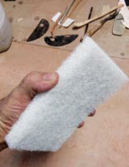 4 After the reduction firing, use a white kitchen scouring pad to remove the refractory slip.