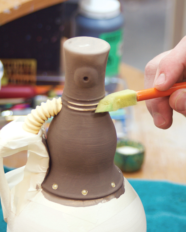 15 Glaze the neck, then sponge the edges and textures to create a weathered finish.