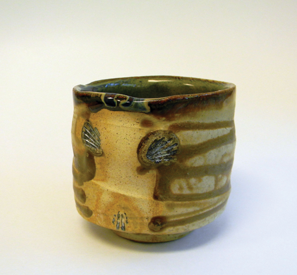 1 Chawan, 182G clay body, Flashing Wood-Ash Glaze, placed on shells, fired to cone 6 in oxidation.