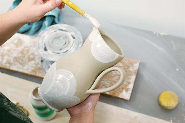 6 Paint underglaze or slip onto different areas of the pitcher, allowing the clay body’s color to be part of the composition. 